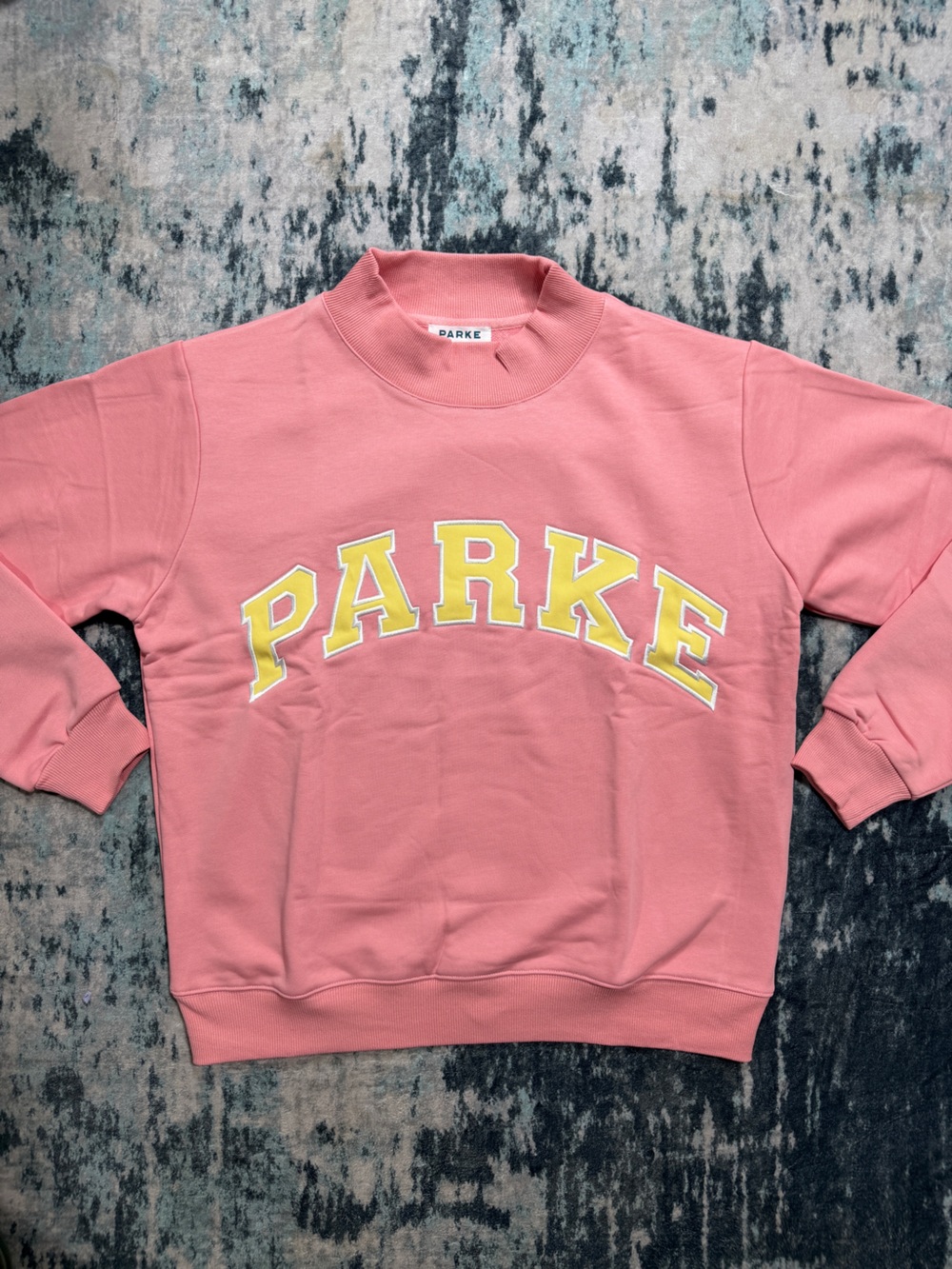 Parke Varsity Mock Neck In size L/XL. Conch + Peel color way!